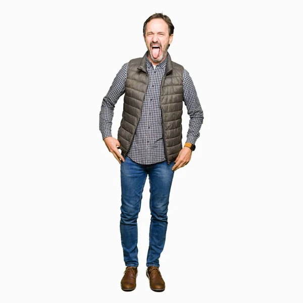 Middle Age Handsome Man Wearing Winter Vest Sticking Tongue Out — Stock Photo, Image