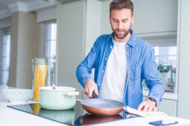 Evde makarna pişiren yakışıklı adam.