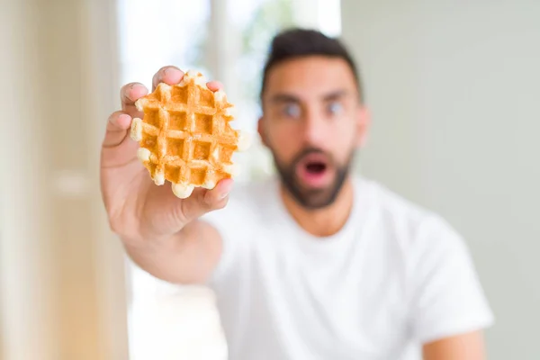 Handsome Hispanic Man Eating Sweet Belgian Waffle Pastry Scared Shock — Stock Photo, Image