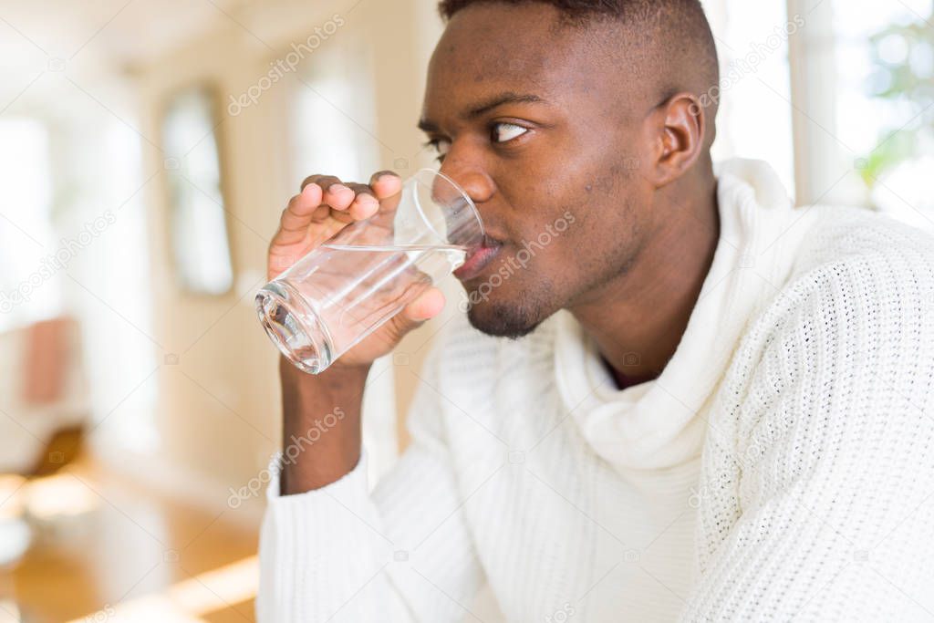 Young african american man drinking a fresh glass of water