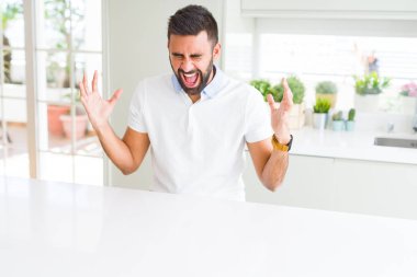 Yakışıklı İspanyol casual beyaz t-shirt ev kızgın ve silah ile başarı için deli kutluyor, kaldırdı ve heyecanlı çığlık gözleri kapalı dostum. Kazanan kavramı