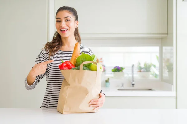 Jonge Vrouw Met Papieren Zak Vol Boodschappen Zeer Gelukkig Wijzend — Stockfoto