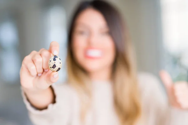 Young Beautiful Woman Holding Fresh Quail Egg Home Happy Big — 스톡 사진