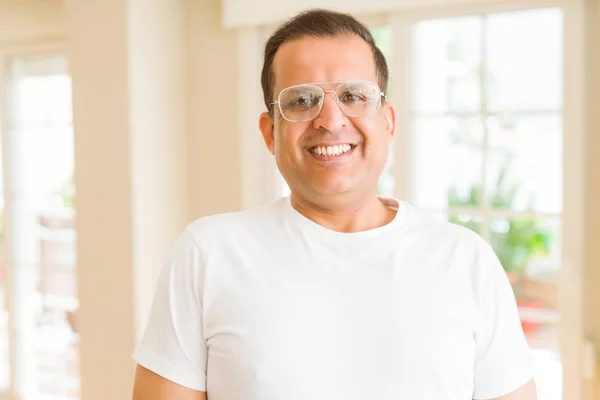 Hombre de mediana edad con gafas sonriendo a la cámara en casa — Foto de Stock