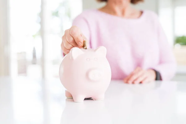 Close-up van senior vrouw zetten een munt binnen Piggy Bank als SAV — Stockfoto