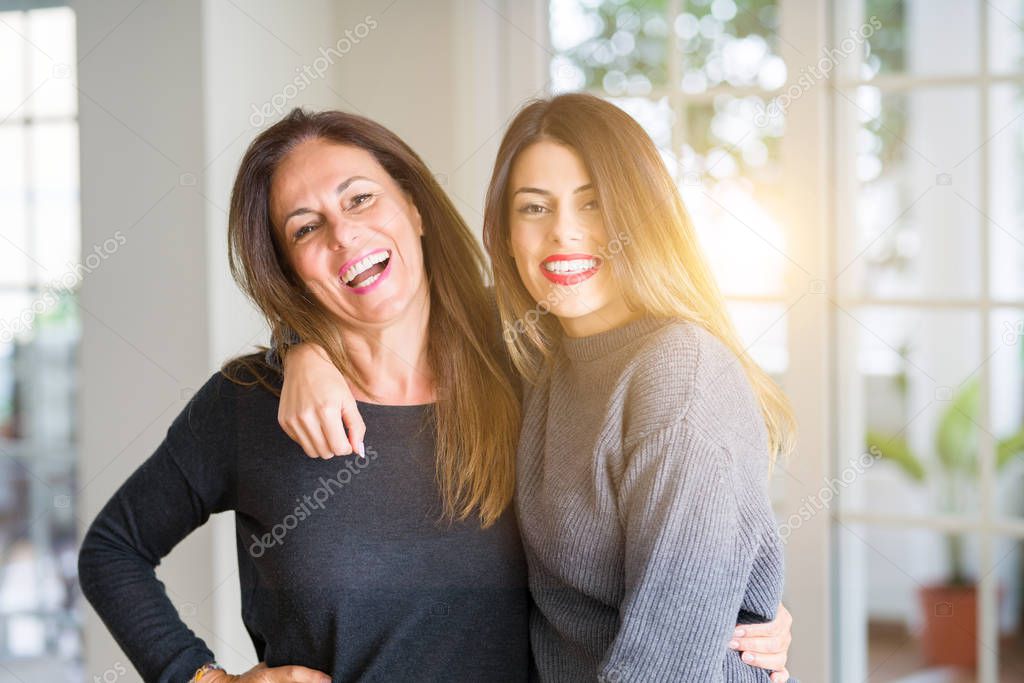 Beautiful family of mother and daughter together, hugging and ki