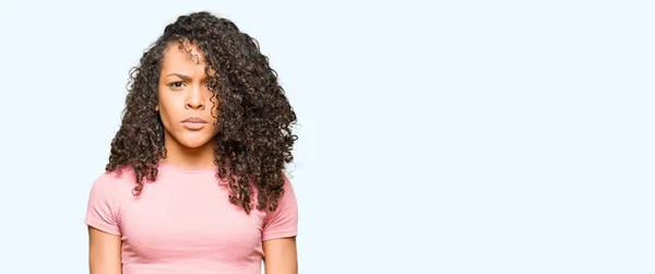 Junge Schöne Frau Mit Lockigem Haar Trägt Rosa Shirt Skeptisch — Stockfoto