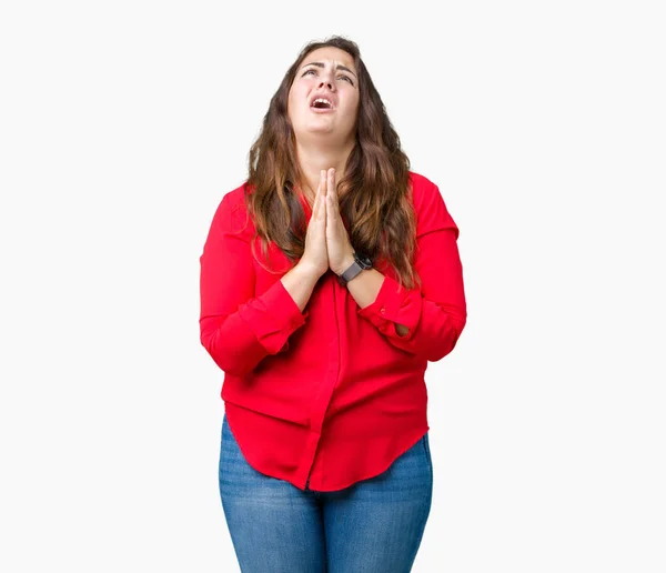 Beautiful plus size young business woman over isolated background begging and praying with hands together with hope expression on face very emotional and worried. Asking for forgiveness. Religion concept.