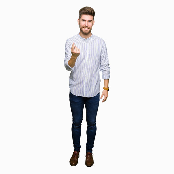 Young handsome man Beckoning come here gesture with hand inviting happy and smiling