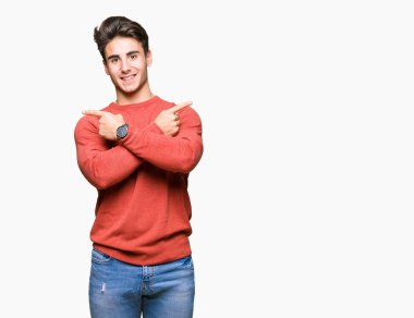 Yakışıklı delikanlı izole arka plan üzerinde işaretleme için her iki parmak, farklı yönde ile katılmıyorum