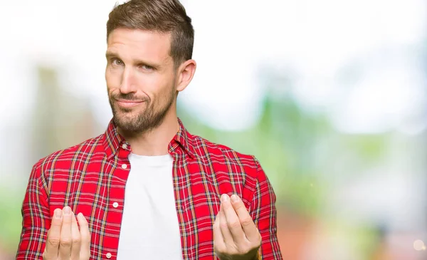 Handsome man wearing casual shirt Doing money gesture with hand, asking for salary payment, millionaire business