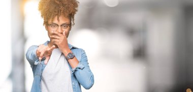 Güzel genç Afro-Amerikan kadın gözlük izole üzerinde gülme sizin parmak el kamerasıyla ağzına, utanç ifadesi işaret eden arka plan