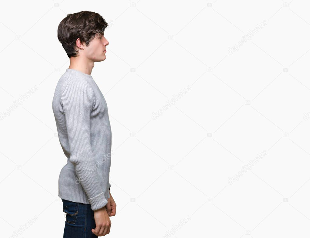 Young handsome man wearing winter sweater over isolated background looking to side, relax profile pose with natural face with confident smile.