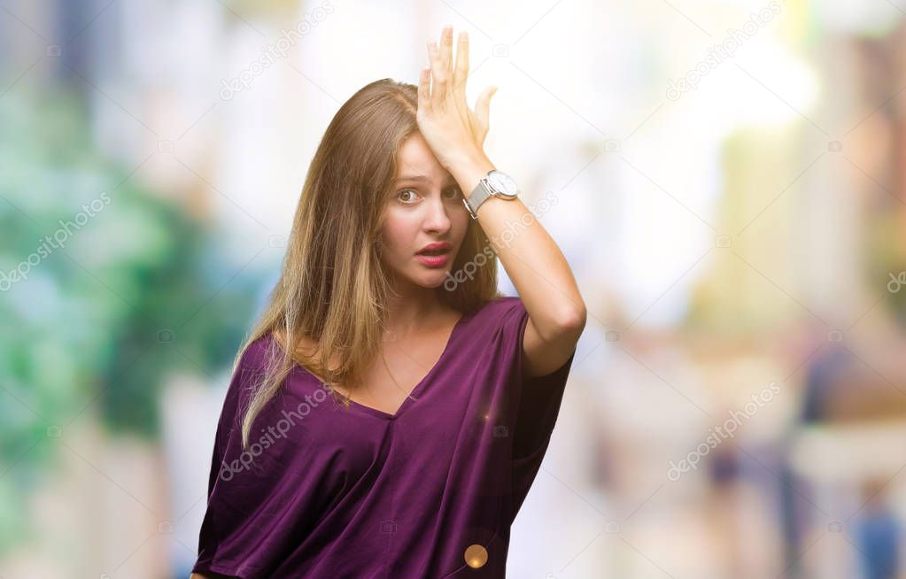 Young beautiful blonde elegant woman over isolated background surprised with hand on head for mistake, remember error. Forgot, bad memory concept.