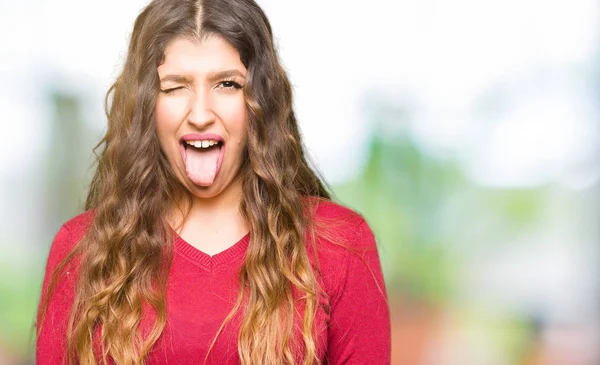 Young Beautiful Woman Wearing Red Sweater Sticking Tongue Out Happy — Stock Photo, Image