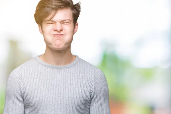 Jovem Homem Bonito Usando Camisola Inverno Sobre Fundo Isolado Soprando — Fotografia de Stock