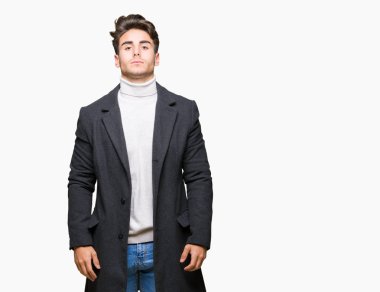 Üzerinde kış ceket giyen genç zarif adam arka plan gevşek yüzünde ciddi bir ifade ile izole. Basit ve doğal kameraya bakıyor.