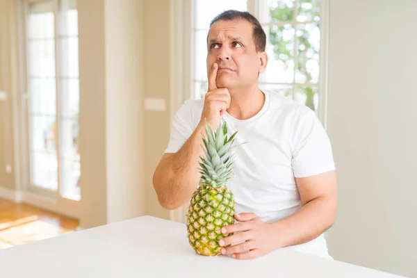 Middle Age Man Eating Fresh Tropical Pineapple Home Serious Face — Stock Photo, Image