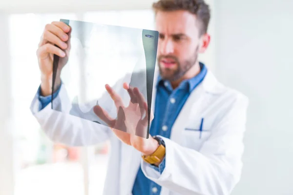 Doctor man looking at x-ray radiography doing body examination