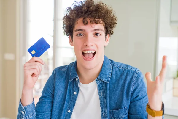 Young Man Holding Credit Card Very Happy Excited Winner Expression — Stock Photo, Image