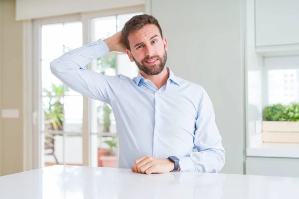 Handsome business man confuse and wonder about question. Uncertain with doubt, thinking with hand on head. Pensive concept.