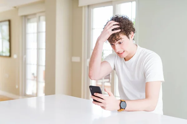 Young Man Using Smartphone Home Stressed Hand Head Shocked Shame — Stock Photo, Image