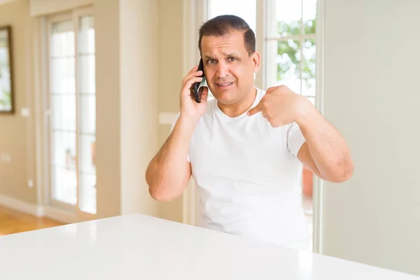 Middle Age Man Calling Using Smartphone Surprise Face Pointing Finger — Stock Photo, Image