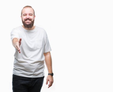 Tebrik ve konuksever dost sunan karşılıklı gülümseyen izole arka plan üzerinde rahat t-shirt giyen genç beyaz hipster adam. Başarılı iş.