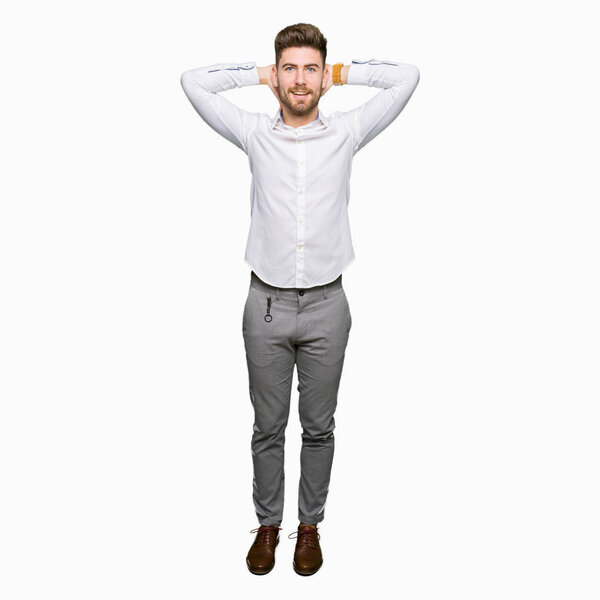 Young handsome business man Relaxing and stretching with arms and hands behind head and neck, smiling happy