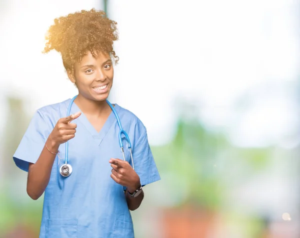 Young african american doctor woman over isolated background pointing fingers to camera with happy and funny face. Good energy and vibes.