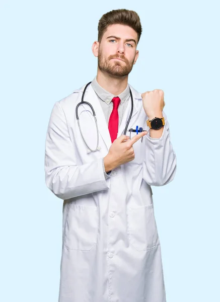 Young Handsome Doctor Man Wearing Medical Coat Hurry Pointing Watch — Stock Photo, Image