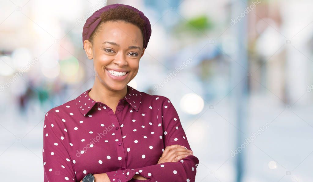 Beautiful young african american woman wearing head scarf over isolated background happy face smiling with crossed arms looking at the camera. Positive person.