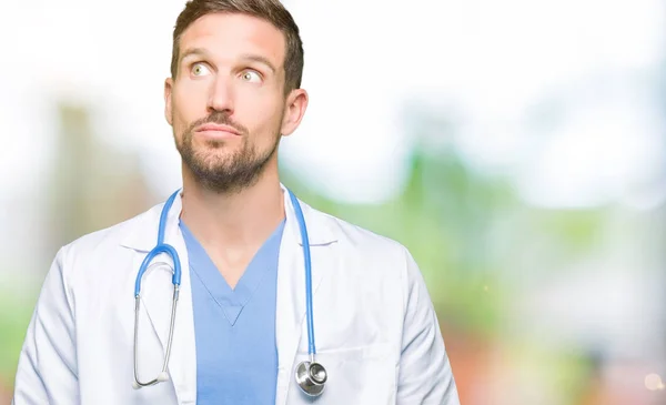 Hombre Guapo Doctor Vistiendo Uniforme Médico Sobre Fondo Aislado Sonriendo — Foto de Stock