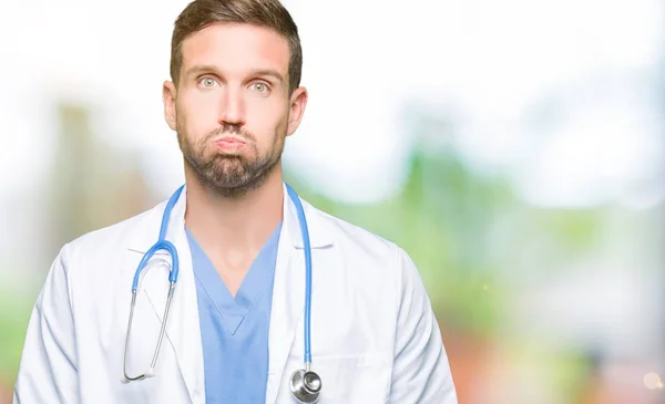 Handsome Doctor Man Wearing Medical Uniform Isolated Background Puffing Cheeks — Stock Photo, Image