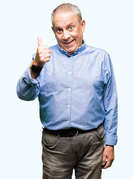 Hareketi el ile mutlu yaşasın yaparken şık gömlek giymiş yakışıklı üst düzey businesss adam. Kameraya bakarak başarı gösteren ile ifade onaylama.