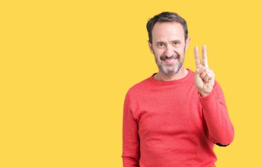 Gösterilen arka plan üzerinde kış kazak giymiş yakışıklı orta yaş ağarmış komuta sizde izole ve parmakları ile işaret kendinden emin ve mutlu gülümseyerek ise ikinci.