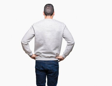 İzole arka plan ayakta geriye doğru uzakta silah ile vücut üzerinde seyir üzerinde sweatshirt giyen genç yakışıklı adam