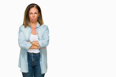 Orta yaş yetişkin kadın izole arka plan şüpheci ve sinir, onaylamayan ifade yüz çapraz kolları üzerinde rahat kot gömlek giymiş. Negatif kişi.