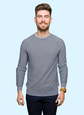 Yüzünde mutlu ve güzel bir gülümseme ile çizgili süveter giymiş yakışıklı delikanlı. Şanslı kişi.