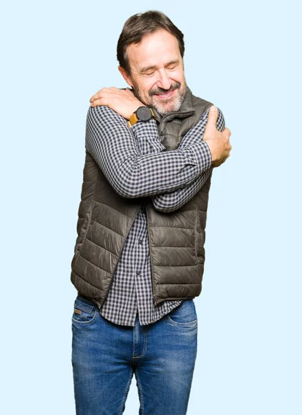 Middle Age Handsome Man Wearing Winter Vest Hugging Oneself Happy — Stock Photo, Image