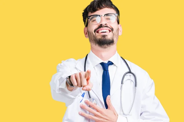 Young doctor man wearing hospital coat over isolated background Laughing of you, pointing to the camera with finger hand over chest, shame expression