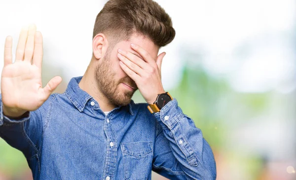 Young Handsome Blond Man Wearing Casual Denim Shirt Covering Eyes — Stock Photo, Image