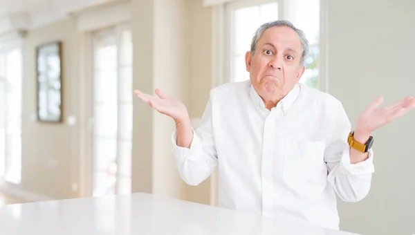 Handsome Senior Man Home Clueless Confused Expression Arms Hands Raised — Stock Photo, Image