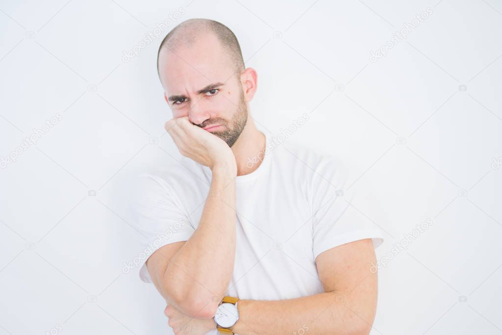 Young bald man over white isolated background thinking looking tired and bored with depression problems with crossed arms.
