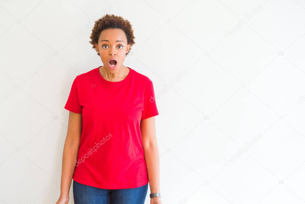 Young beautiful african american woman over white background afraid and shocked with surprise expression, fear and excited face.