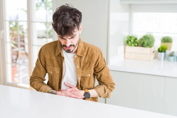 Young Man Wearing Casual Jacket Sitting White Table Hand Stomach — Stock Photo, Image