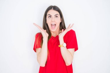 Young beautiful woman wearing casual red t-shirt over white isolated background celebrating crazy and amazed for success with arms raised and open eyes screaming excited. Winner concept