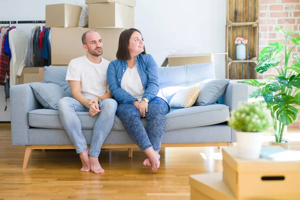 Young Couple Sitting Sofa Arround Cardboard Boxes Moving New House — Stockfoto