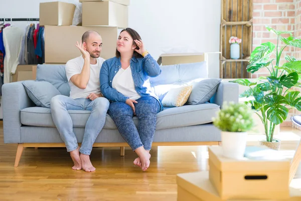 Young Couple Sitting Sofa Arround Cardboard Boxes Moving New House — Stockfoto