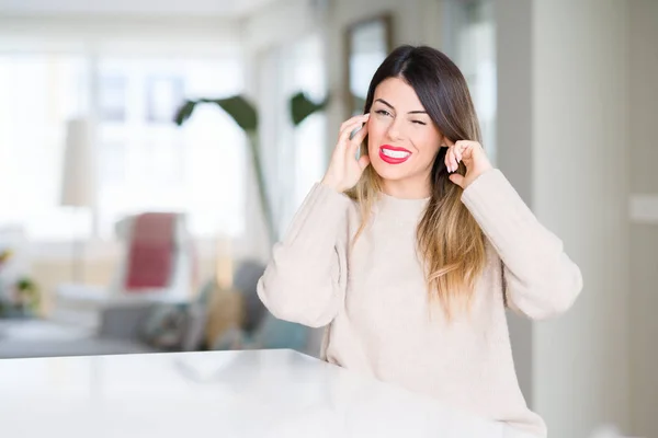 Young Beautiful Woman Wearing Winter Sweater Home Covering Ears Fingers — Stock Photo, Image